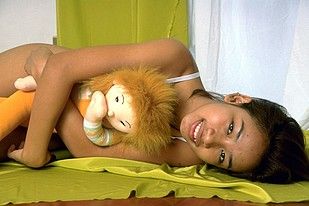 Short haired Korean babe posing naked with a rag doll