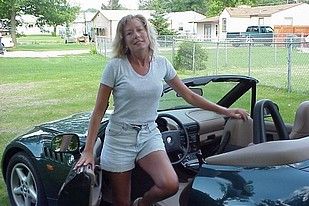 Blonde with big boobs posing in her nice car