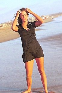 Cute model flashing the camera down on the beach