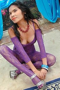 Asian sex pot posing in just her purple lace bodysuit
