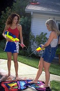 Watergun shooting lesbians babes licking pussy outside