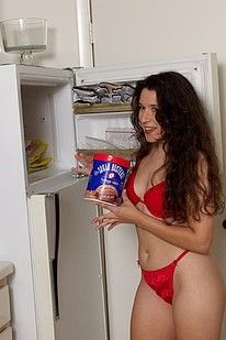 Dark haired sweetie posing naked on a kitchen counter